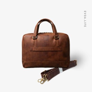Built for serious workdays, this full-grain leather laptop bags combines clean design with lasting durability. The structured body protects your laptop while aging beautifully over time. A padded main compartment, space for daily essentials, sturdy top handles, and a detachable shoulder strap offer comfort, flexibility, and a confident professional presence wherever work takes you.