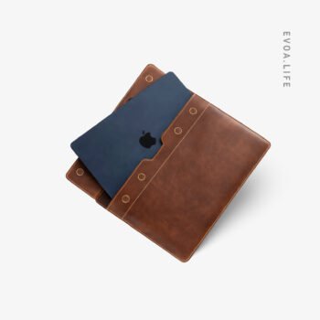 Built for serious workdays, this full-grain leather laptop sleeve combines clean design with lasting durability. The structured body protects your laptop while aging beautifully over time. A padded main compartment, space for daily essentials, sturdy top handles, and a detachable shoulder strap offer comfort, flexibility, and a confident professional presence wherever work takes you