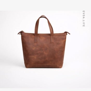 This brown Leather Tote Bags is a stylish and versatile accessory designed specifically for women. Its spacious interior makes it perfect for carrying everyday essentials like a laptop, notebooks, makeup kits, and other personal items. Whether for office, university, or casual outings, its classic design complements any outfit from formal attire to casual wear. Combining durability with elegance, it is an ideal choice for women who prioritize both fashion and functionality in their daily lives.