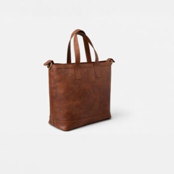 This brown Leather Tote Bags is a stylish and versatile accessory designed specifically for women. Its spacious interior makes it perfect for carrying everyday essentials like a laptop, notebooks, makeup kits, and other personal items. Whether for office, university, or casual outings, its classic design complements any outfit from formal attire to casual wear. Combining durability with elegance, it is an ideal choice for women who prioritize both fashion and functionality in their daily lives.